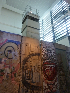 Pieces of Berlin Wall with Checkpoint Charlie Tower behind